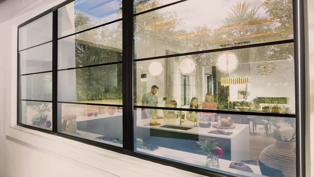 A light-filled PGT home opens family life to the landscape through expansive impact-resistant windows.